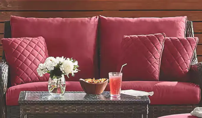 Red outdoor lounge set with sofa cushions and patio table