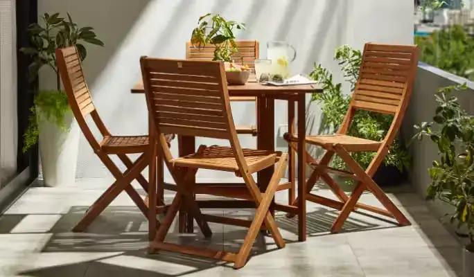 Compact wooden outdoor dining set with foldable chairs