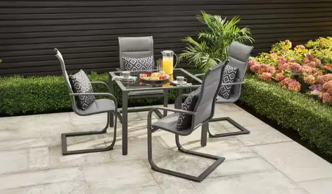 Tan cushioned outdoor lounge chairs with matching loveseat