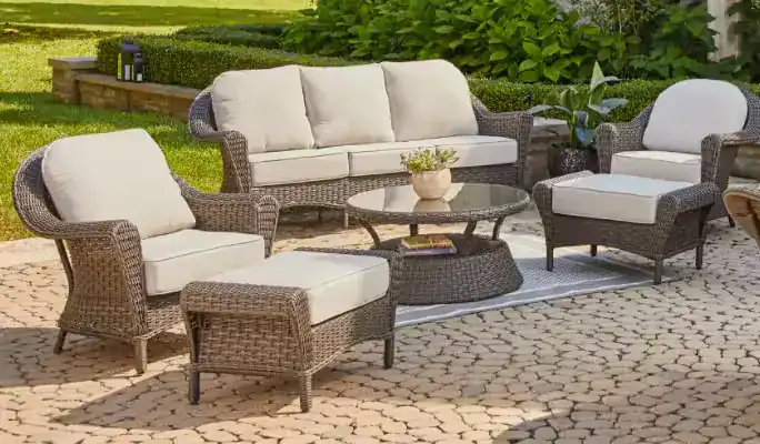 Outdoor dining set with mesh chairs and decorative plants