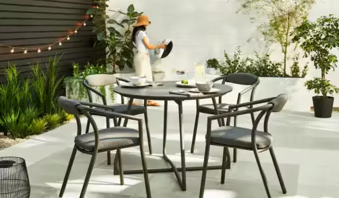 Contemporary outdoor dining set with cushioned chairs