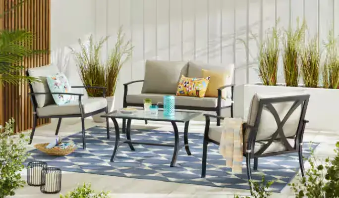 Wood and wicker outdoor seating set arranged on stone patio